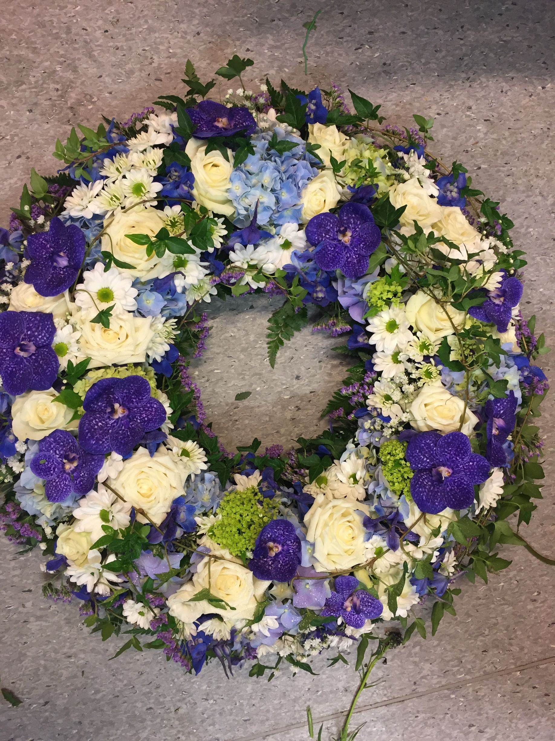 Krans med blå vanda-orkidé og hvite roser